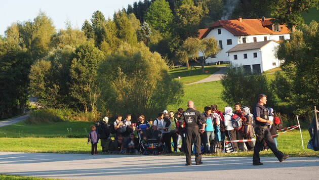 Auf der bayrischen Seite der Grenze warten Flüchtlinge auf den Abtransport mit Bussen (Bild: Gemeinde Breitenberg)