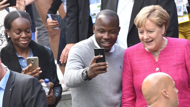 Merkel lässt sich von Besuchern am Tag der Offenen Tür des Bundeskanzleramtes fotografieren. (Bild: APA/dpa/Ralf Hirschberger)