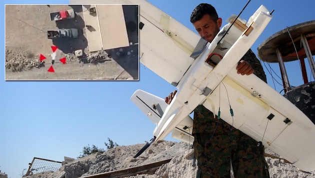 Ein syrischer Soldat mit einer abgeschossenen IS-Drohne (Bild: AFP, YouTube.com)