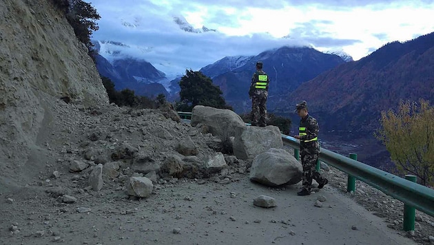 Eine von abgesplitterten Felsbrocken verschüttete Straße in Tibet. (Bild: AP)