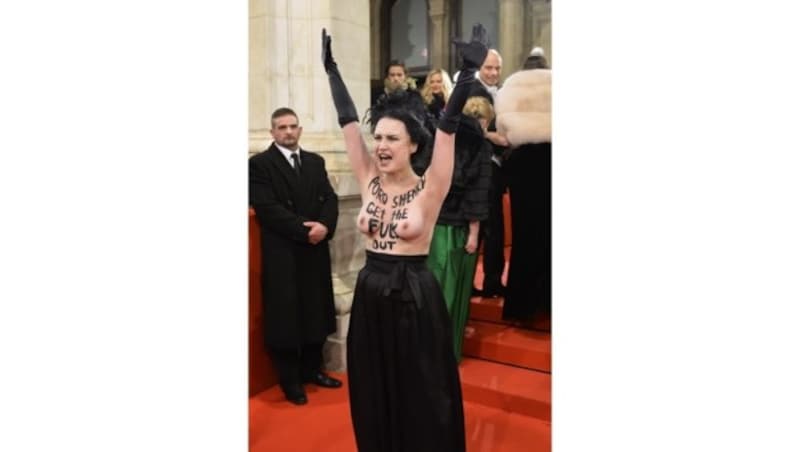 Eine Aktivistin kam im halben Abendkleid zum Opernball. (Bild: APA/HERBERT NEUBAUER)