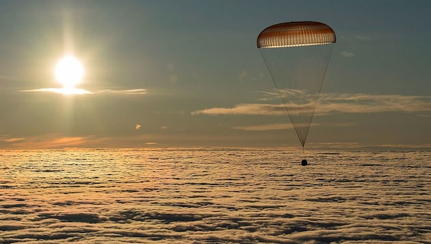 Die „Sojus“-Kapsel kurz vor ihrer Landung in Kasachstan über der Wolkendecke (Bild: NASA/Paul Ingalls)