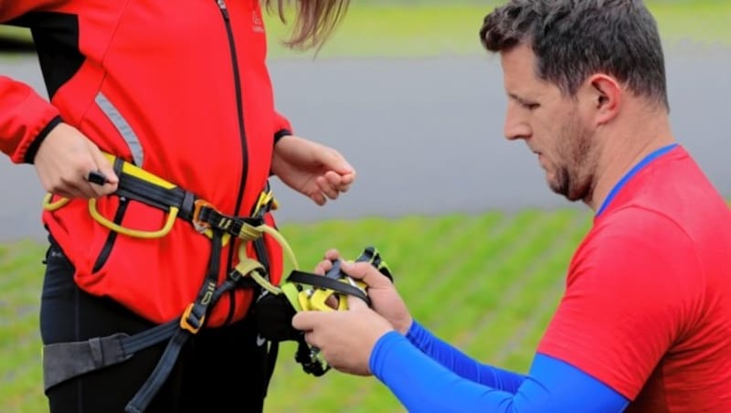 Michael Koller zeigt Elisa, wie man das Klettersteig-Set richtig mit dem Klettergurt verbindet (Bild: Wallner Hannes/Kronenzeitung)