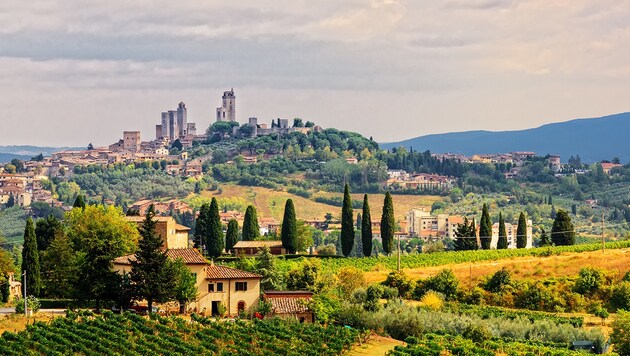 Die Hügelstadt San Gimignano (Bild: stock.adobe.com, krone.at-Grafik)