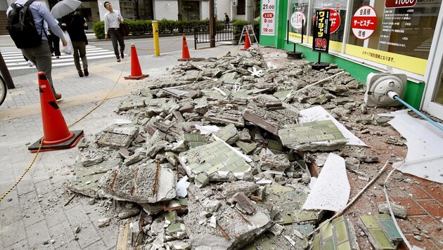 Mauerteile liegen nach dem Beben auf einer Staße verstreut. (Bild: AP)