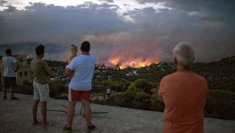 Viele Bewohner konnten sich in Sicherheit bringen. Machtlos müssen sie mit ansehen, wie ihr gesamtes Hab und Gut den Flammen zum Opfer fällt - doch sie sind am Leben. (Bild: AFP)