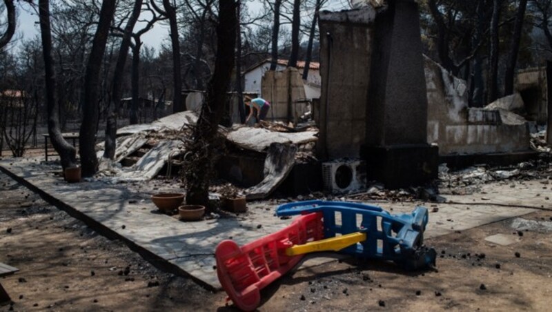 Eine Frau sucht in den Resten ihres Hauses in Neos Voutzas nach nicht zerstörten Habseligkeiten. (Bild: AFP)