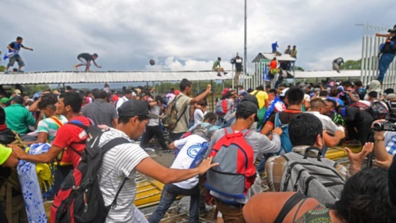 Nach dem Durchbruch auf der guatemaltekischen Seite der Grenze liefen die Honduraner über eine Brücke weiter Richtung mexikanischer Grenze. (Bild: AFP)