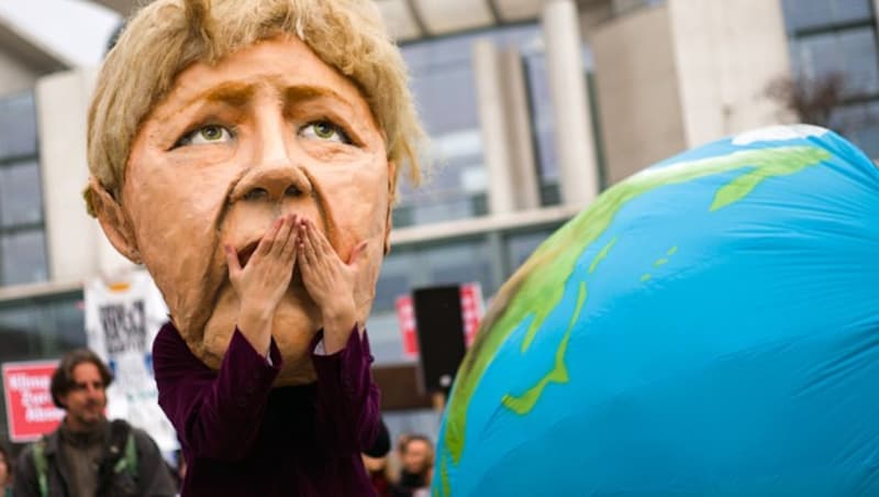 Eine Klimaaktivistin, die sich als Angela Merkel verkleidet hat, zeigt sich entsetzt über die Klimaschutzpolitik der Kanzlerin. (Bild: AP)