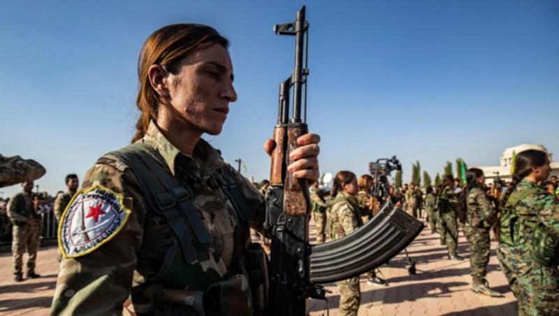 Kurdische Soldatinnen während eines Begräbnisses ziviler Opfer, die während der türkischen Offensive ums Leben gekommen waren (Bild: APA/AFP/Delil SOULEIMAN)