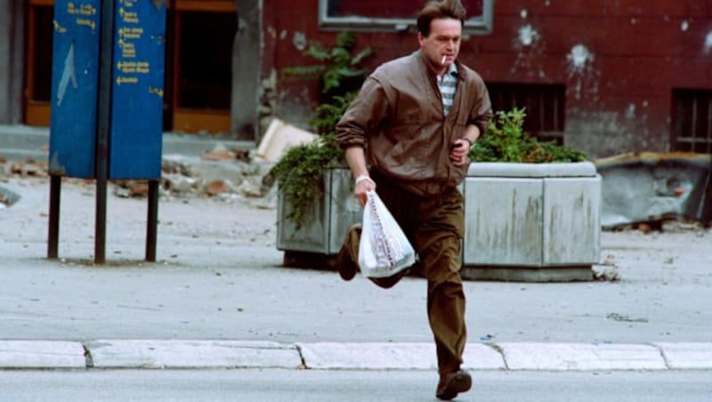 Archivaufnahme aus dem Jahr 1992: Ein Bewohner Sarajevos überquert im Laufschritt eine Straße, die sich in der sogenannten Sniper Alley (Heckenschützen-Gasse) befindet. (Bild: AFP)