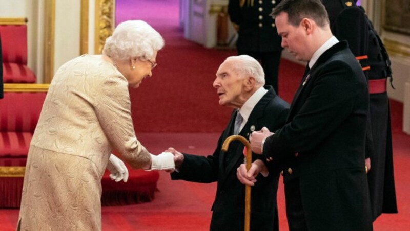 Queen Elizabeth schüttelt Harry Billinge die Hand. (Bild: AP)