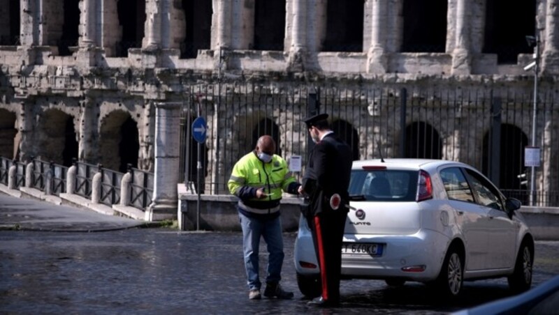 Ein Polizist bei einer Verkehrskontrolle in Rom: Am Mittwoch war die Zahl der Covid-19-Patienten auf Intensivstationen den fünften Tag in Folge rückläufig. (Bild: AFP)