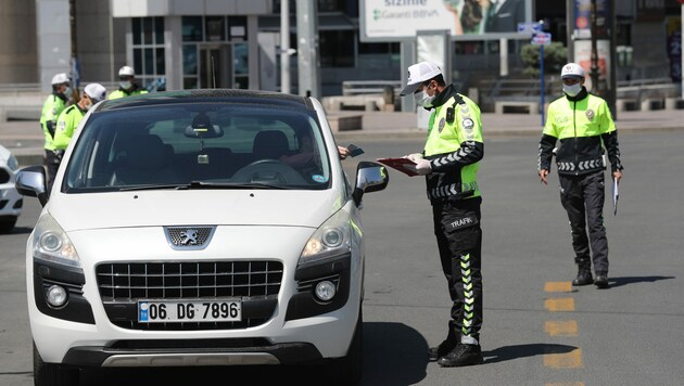 Polizisten kontrollieren Autofahrer am Kizilay-Platz in der türkischen Hauptstadt Ankara. (Bild: AFP)