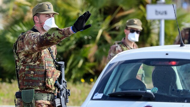 Italienische Soldaten kontrollieren Fahrzeuge bei der Einreise nach Italien. (Bild: AFP)