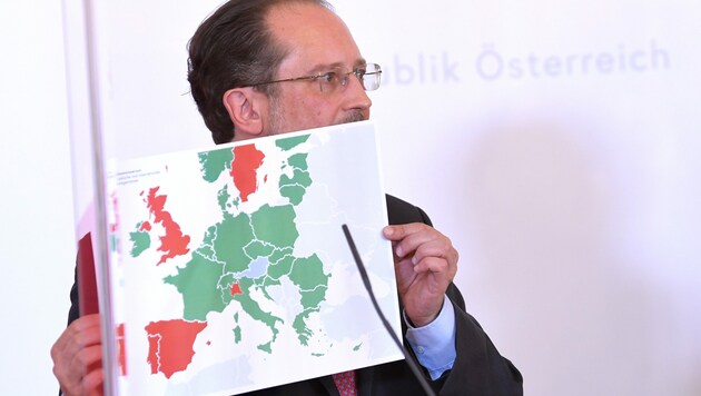 Außenminister Schallenberg mit einer Karte der „neuen Reisefreiheit“ (Bild: APA/ROLAND SCHLAGER)