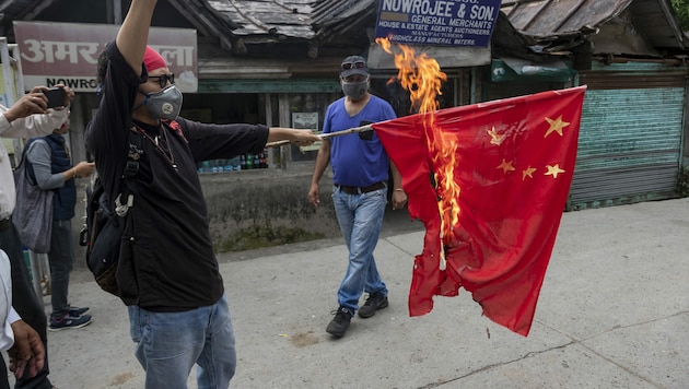 Ein tibetanischer Aktivist verbrennt eine chinesische Flagge als Zeichen des Protests gegen die chinesische Besatzung indischen Territoriums und Tibets. (Bild: AP)