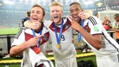 Andre Schürrle (Mitte) mit Mario Götze und Jerome Boateng (Bild: AFP)