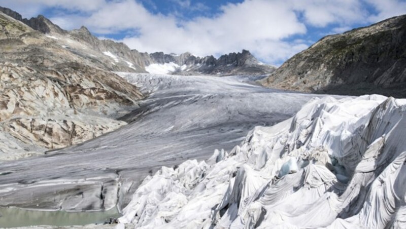 Eine mit Planen abgedeckte Eisgrotte am Ende des Rhonegletscher oberhalb von Gletsch am Furkapass. (Bild: APA/Keystone/Urs Flueeler)