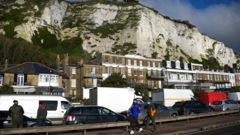 Die Autos stauen sich vor dem Hintergrund der weißen Kreidefelsen von Dover vor dem Ärmelkanal. (Bild: AP)