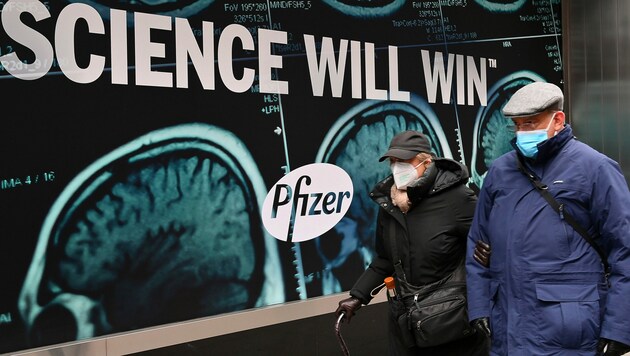 Pfizer (hier im Bild Passanten vor der Firmenzentrale in New York City zu sehen) ist überzeugt: „Wissenschaft wird siegen.“ (Bild: APA/AFP/Angela Weiss)