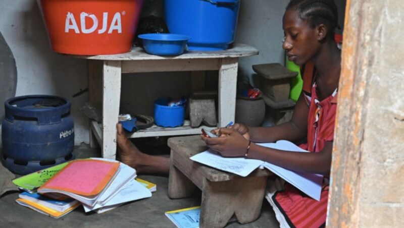 Ein Mädchen in Abidjan nutzt kostenlose Lernangebote per WhatsApp. (Bild: APA/AFP/ISSOUF SANOGO)