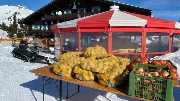 Zur freien Entnahme für alle Skifahrer: Wirt Patrick Radacher hat kiloweise Kartoffeln und Zwiebeln vor seine Breiteckalm auf der Schmittenhöhe gestellt. (Bild: zVg)