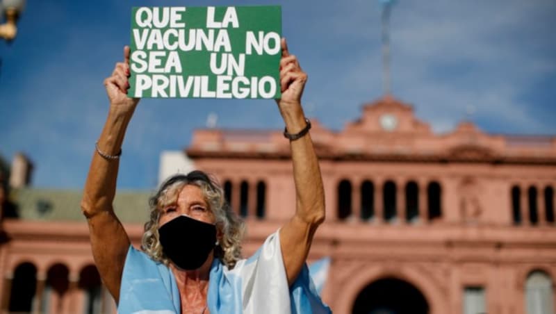 „Impfungen sollten kein Privileg sein“, fordert diese Demo-Teilnehmerin am Samstag. (Bild: AP Photo/Natacha Pisarenko)