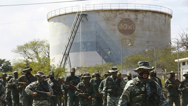 Venezolanische Soldaten patrouillieren vor einer Ölraffinerie. (Bild: AP)