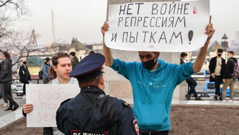 „Gegen Krieg, Unterdrückung und Folter!“ steht auf dem Plakat dieses Mannes bei einer Demonstration in Wladiwostok. (Bild: APA/AFP/Pavel KOROLYOV)