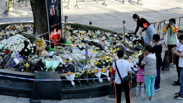 An der Stelle, an der die Menschen niedergestochen wurden, legen die Menschen Blumen nieder. (Bild: AFP/STR)