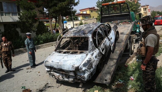 Eine Rakete, die in der Nähe des Präsidentenpalasts in Kabul einschlug, setzte diesen Wagen in Brand. (Bild: AFP)