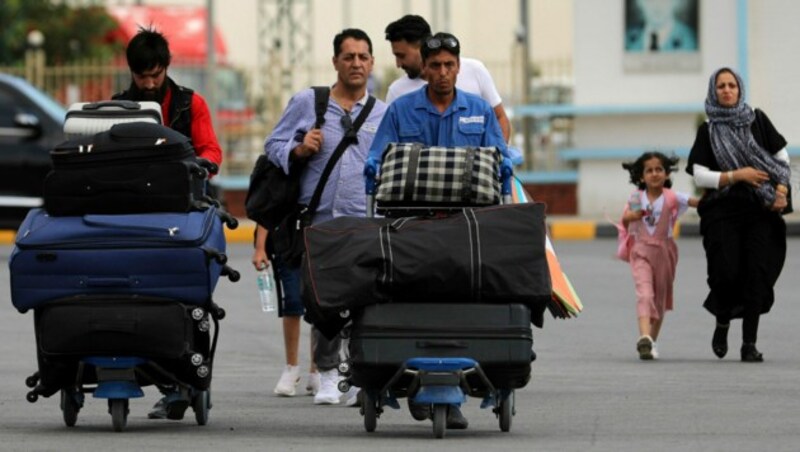 Einwohner von Kabul auf dem Weg zur Abflughalle. Zahlreiche Menschen fliehen aus der Stadt. (Bild: AP)