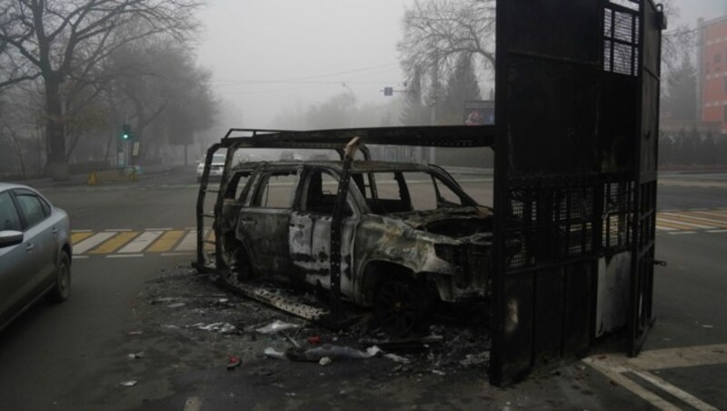 Ausgebranntes Polizeiauto in Almaty (Bild: AP)