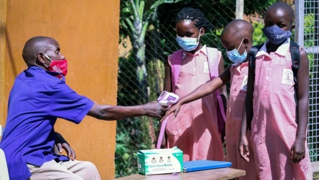 Beim Eingang in die Schule wird den Kindern Fieber gemessen. (Bild: AP)