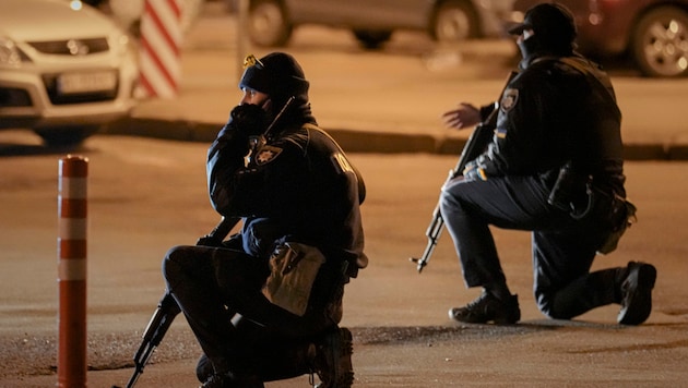 Ukrainische Polizisten gestikulieren während eines Luftangriffsalarms vor dem Bahnhof in Kiew (Archivbild). (Bild: The Associated Press)