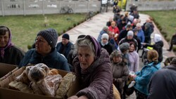 Menschen in der Ukraine bei der Lebensmittelausgabe (Bild: AP)
