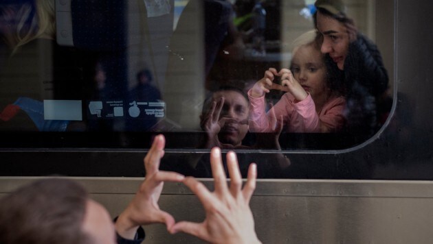 Un ucraniano se despide de su esposa e hija, quienes huyen de su país de origen a través de Polonia.  (Imagen: Prensa Asociada)