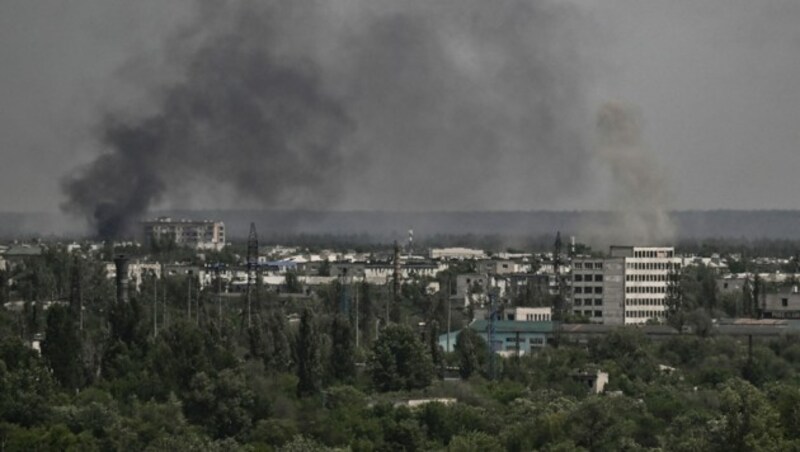 Rauch und Schmutz steigen aus der Stadt Sjewjerodonezk während des Beschusses in der ostukrainischen Region Donbass auf. (Bild: APA/AFP/ARIS MESSINIS)