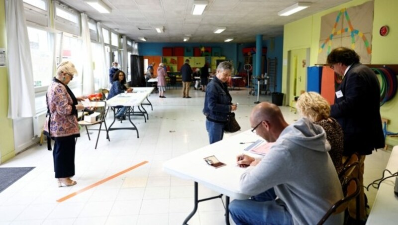 In einem Wahllokal in der nordfranzösischen Stadt Le Havre kommen die Wähler früh an, um ihre Stimme in der zweiten Phase der Parlamentswahlen abzugeben. (Bild: APA/AFP/Sameer Al-DOUMY)