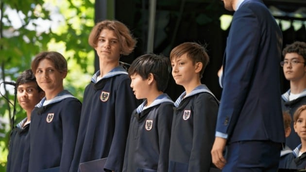 Arsenii (13), tercero desde la izquierda, entregando el uniforme.  (Imagen: lukas beck)
