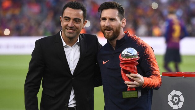 Xavi (li.) und Lionel Messi (Bild: AFP OR LICENSORS)