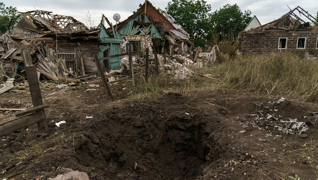Ein Krater von einem russischen Raketenangriff neben beschädigten Häusern in Kramatorsk (Region Donezk) (Bild: The Associated Press)