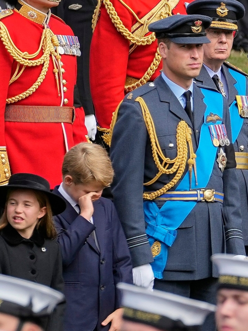 Prinz George reibt sich beim Begräbnis der Queen die Augen (Bild: Martin Meissner / AP / picturedesk.com)
