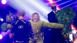Katja Burkard entschlüpft ihrem Brokkoli-Kostüm in der ProSieben-Show "The Masked Singer. (Bild: Rolf Vennenbernd / dpa / picturedesk.com)