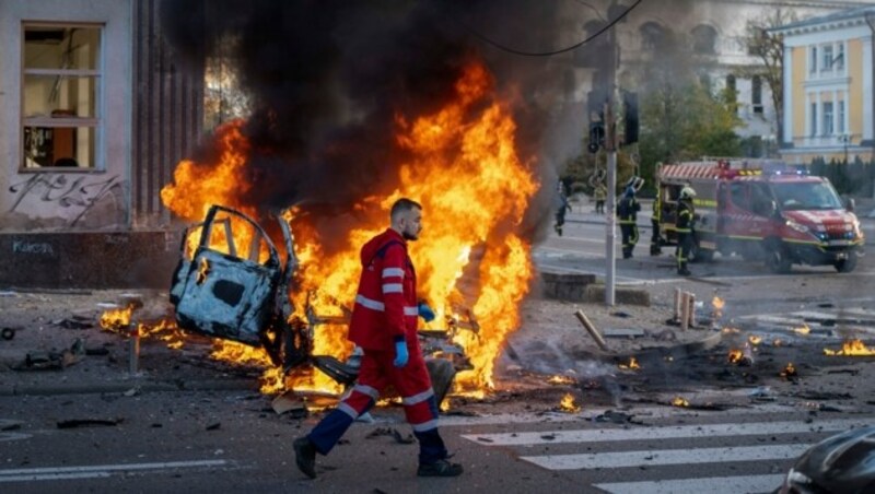 Ein Sanitäter läuft an einem brennenden Auto nach einem russischen Angriff in Kiew vorbei. (Bild: The Associated Press)