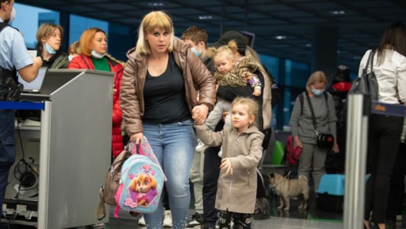 Flüchtlinge aus der Ukraine warten nach der Landung auf dem Flughafen in Frankfurt am Main auf die Registrierung durch die Bundespolizei. (Bild: APA/AFP/POOL/Boris Roessler)