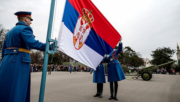 Serbische Soldaten beim Hissen der Flagge am Nationalfeiertag im Februar 2022 (Bild: APA/AFP/Andrej ISAKOVIC)