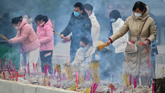 Räucherstäbchen werden vor einem Tempel in Wuhan angezündet. (Bild: AFP)