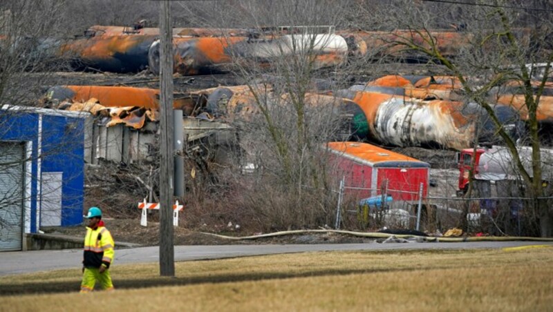 Die ausgebrannten Waggons warten auf diesem Feld auf ihre Entsorgung. (Bild: AP)